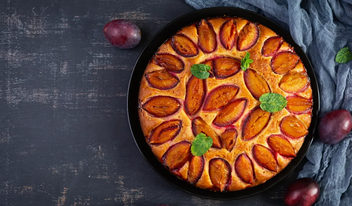 delicious plum cake on wooden background homemade 2023 11 27 05 25 51 utc