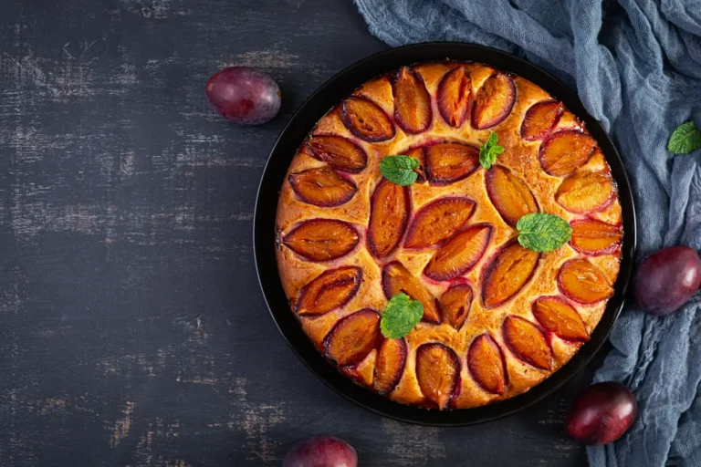 delicious plum cake on wooden background homemade 2023 11 27 05 25 51 utc